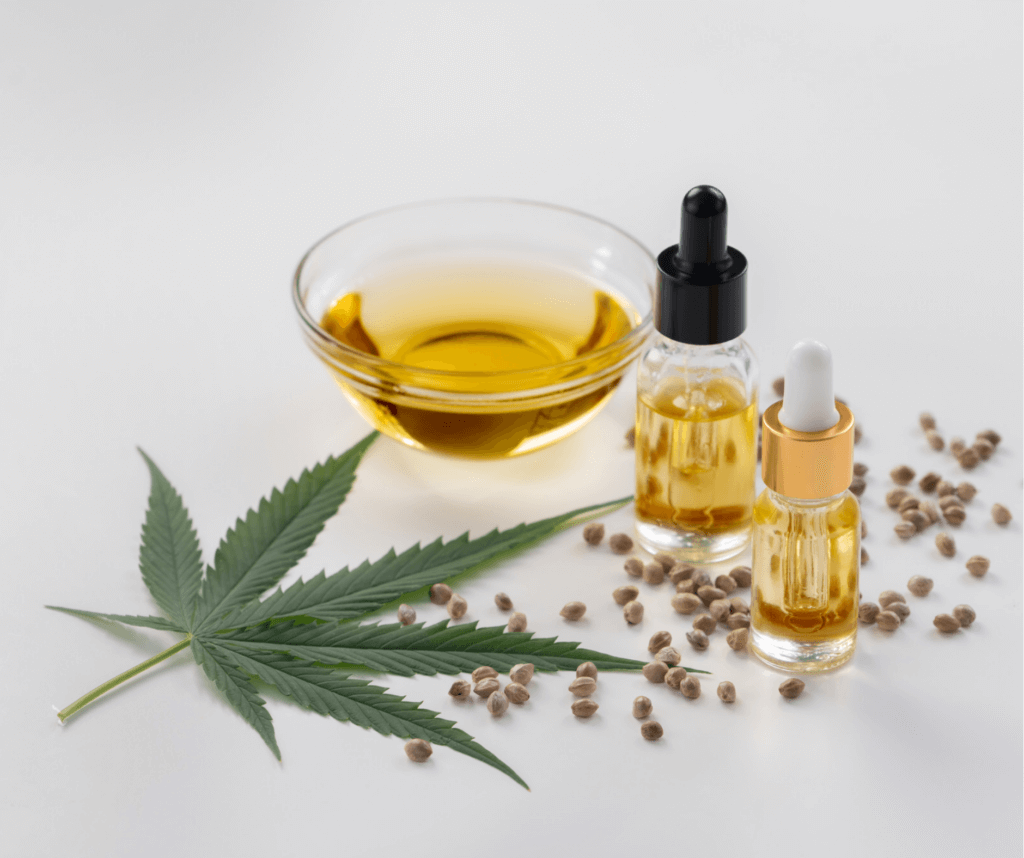 CBD Oel und ein Blatt der Cannabispflanze